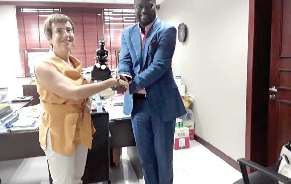 EU Mr Frank Annor-Dompreh presenting an artefact to Ms Diana Acconcia