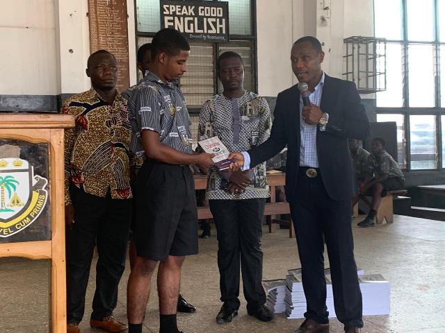Dr. Godson Afful presents copies of his book 'Charisma Plus Character' to Adisadel College